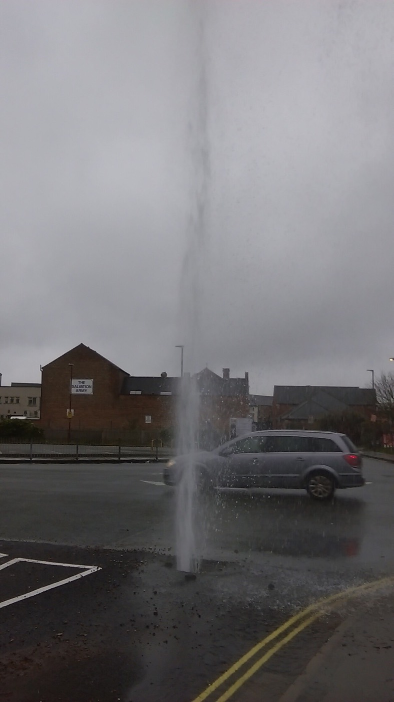 Water shooting up from a broken pipe
