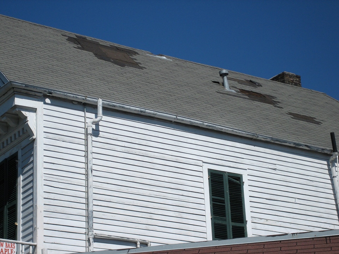 Shingles missing from a roof after wind