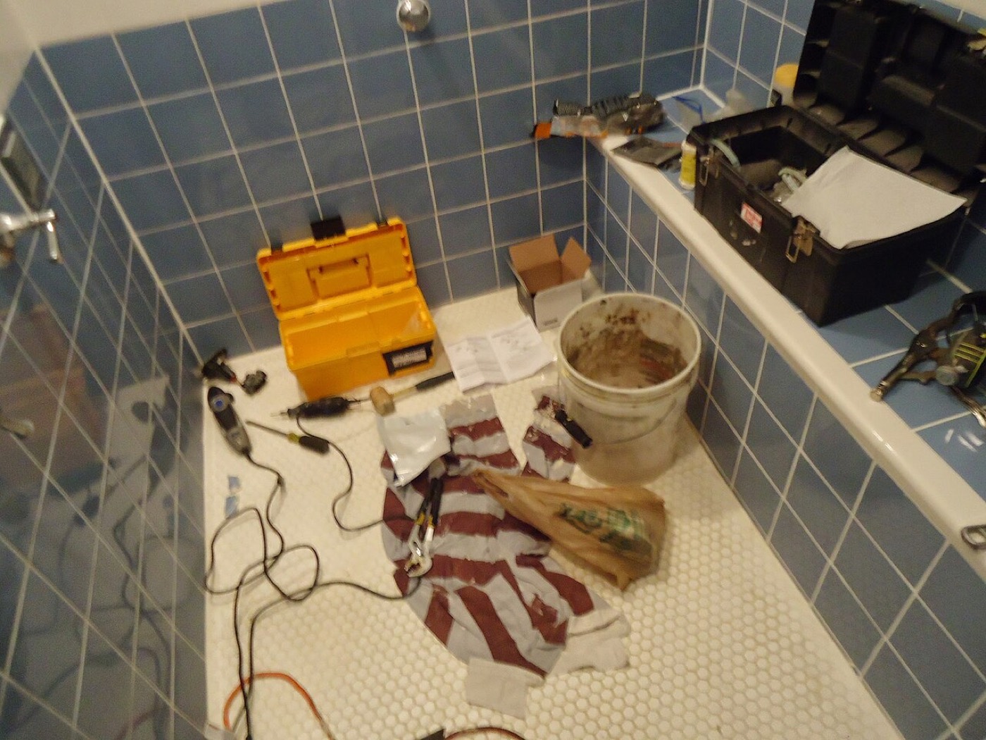 Tools laid out in a shower during a repair